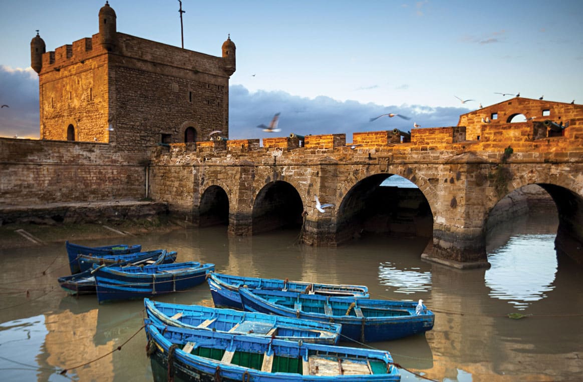 Essaouira port with traditional wooden boats and fresh seafood market