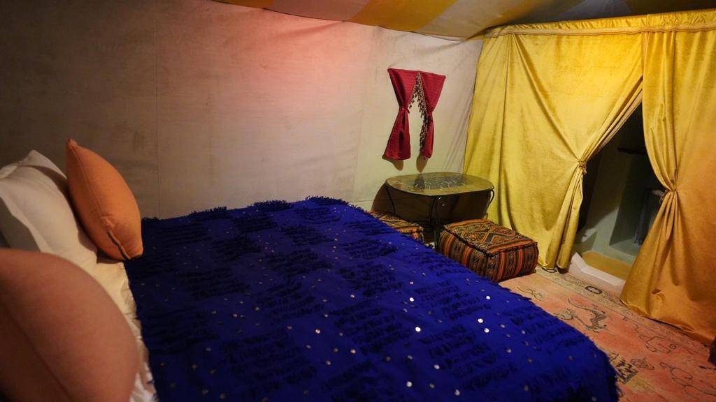 Camel caravan crossing Erg Chebbi dunes at magical sunset hour