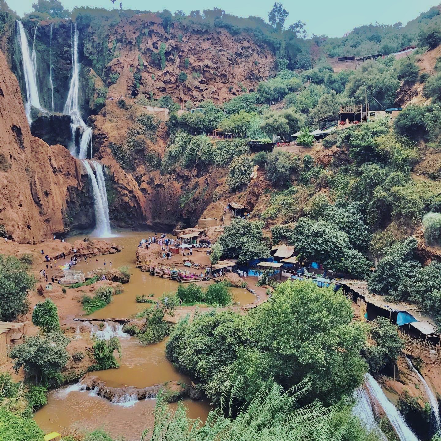 Panoramic view of Ouzoud waterfalls with multiple cascades and greenery